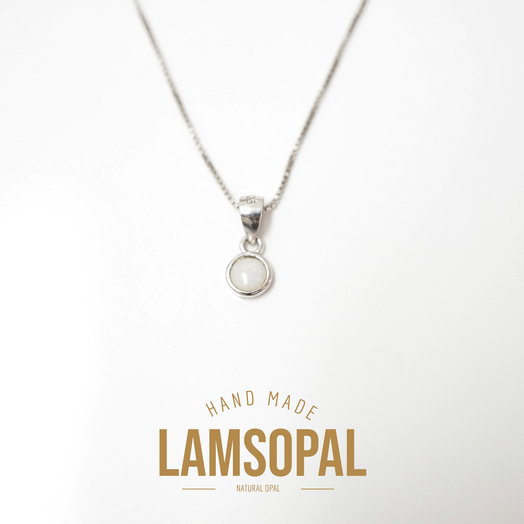 A silver necklace with a small circular pendant containing a white natural opal, displayed on a clean white background with a gold-colored 'LAMSOPAL' brand logo at the bottom.
