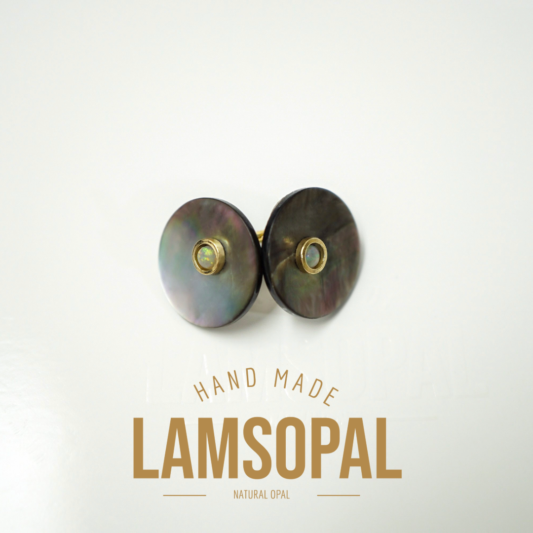 Two round Lamsopal natural opal stud earrings with iridescent green and purple tones and gold settings, displayed on a clean white background with 'HAND MADE LAMSOPAL' text below.