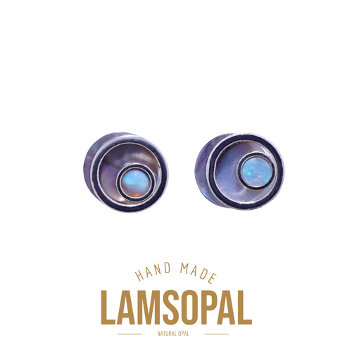 A pair of handmade Lamsopal natural opal ear plugs shown on a white background with gold text below reading 'HAND MADE LAMSOPAL NATURAL OPAL'.