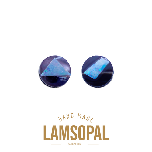 A pair of handmade Lamsopal stud earrings featuring natural opal triangles set in a dark blue bezel, with 'HAND MADE LAMSOPAL' text printed below on a white background.