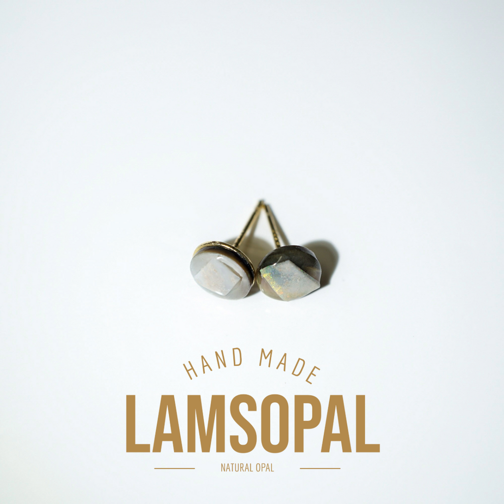 A pair of handmade Lamsopal natural opal stud earrings with gold-toned posts, displayed on a clean white background with gold text below reading 'HAND MADE LAMSOPAL NATURAL OPAL'.