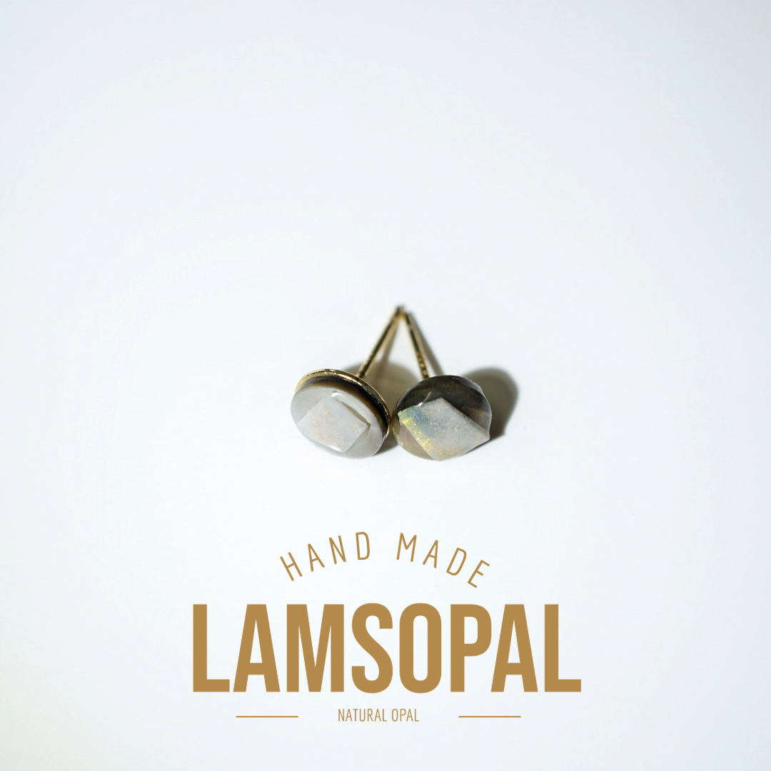 A pair of handmade Lamsopal natural opal stud earrings with gold-toned posts, displayed on a clean white background with gold text below reading 'HAND MADE LAMSOPAL NATURAL OPAL'.