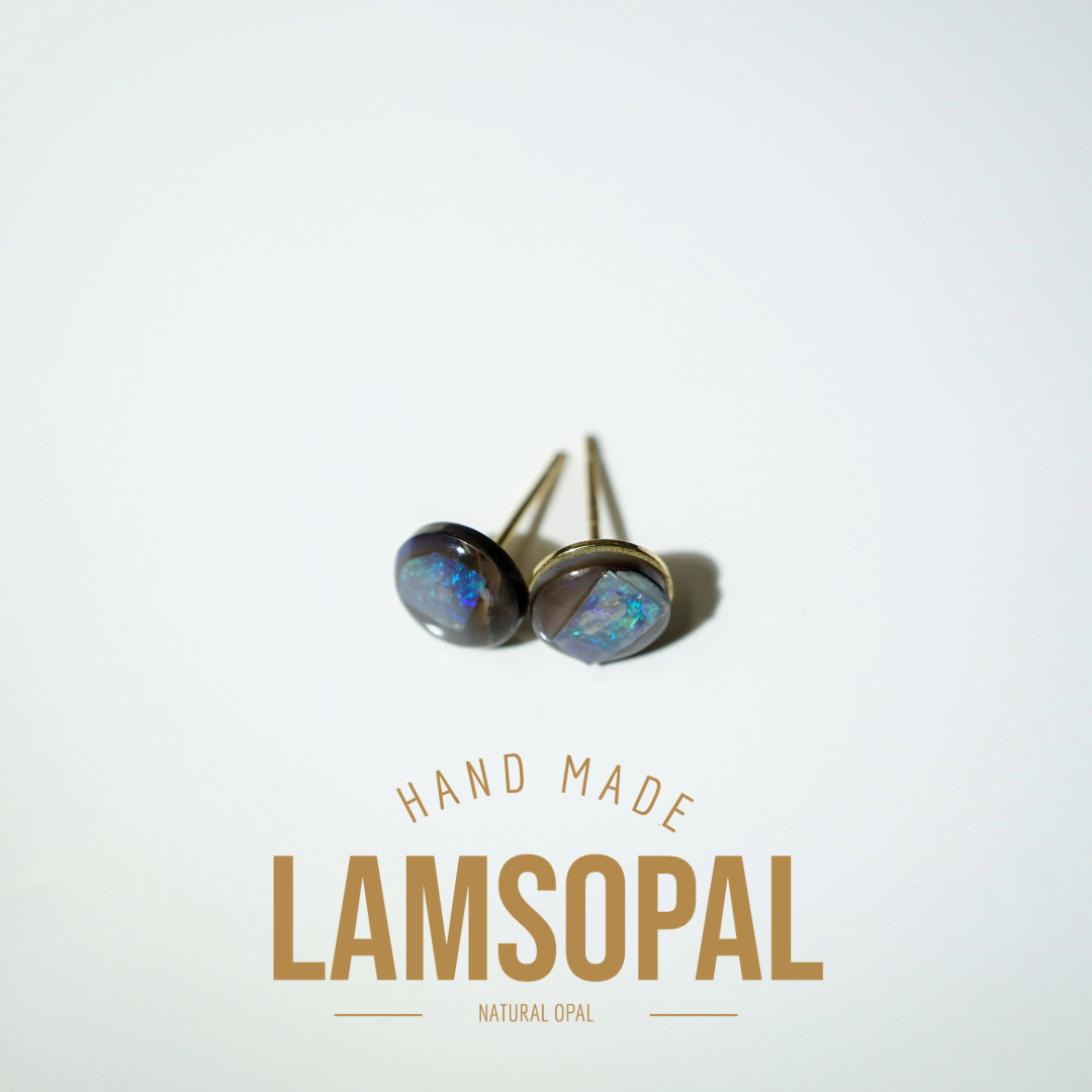 A pair of handmade Lamsopal natural opal stud earrings with gold-toned posts and bezel settings, displayed on a clean white background with gold text below reading 'HAND MADE LAMSOPAL NATURAL OPAL'.