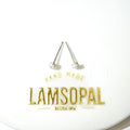 A pair of Lamsopal natural opal stud earrings with silver posts and round iridescent opal gemstones, displayed on a white circular backing card with gold foil branding.