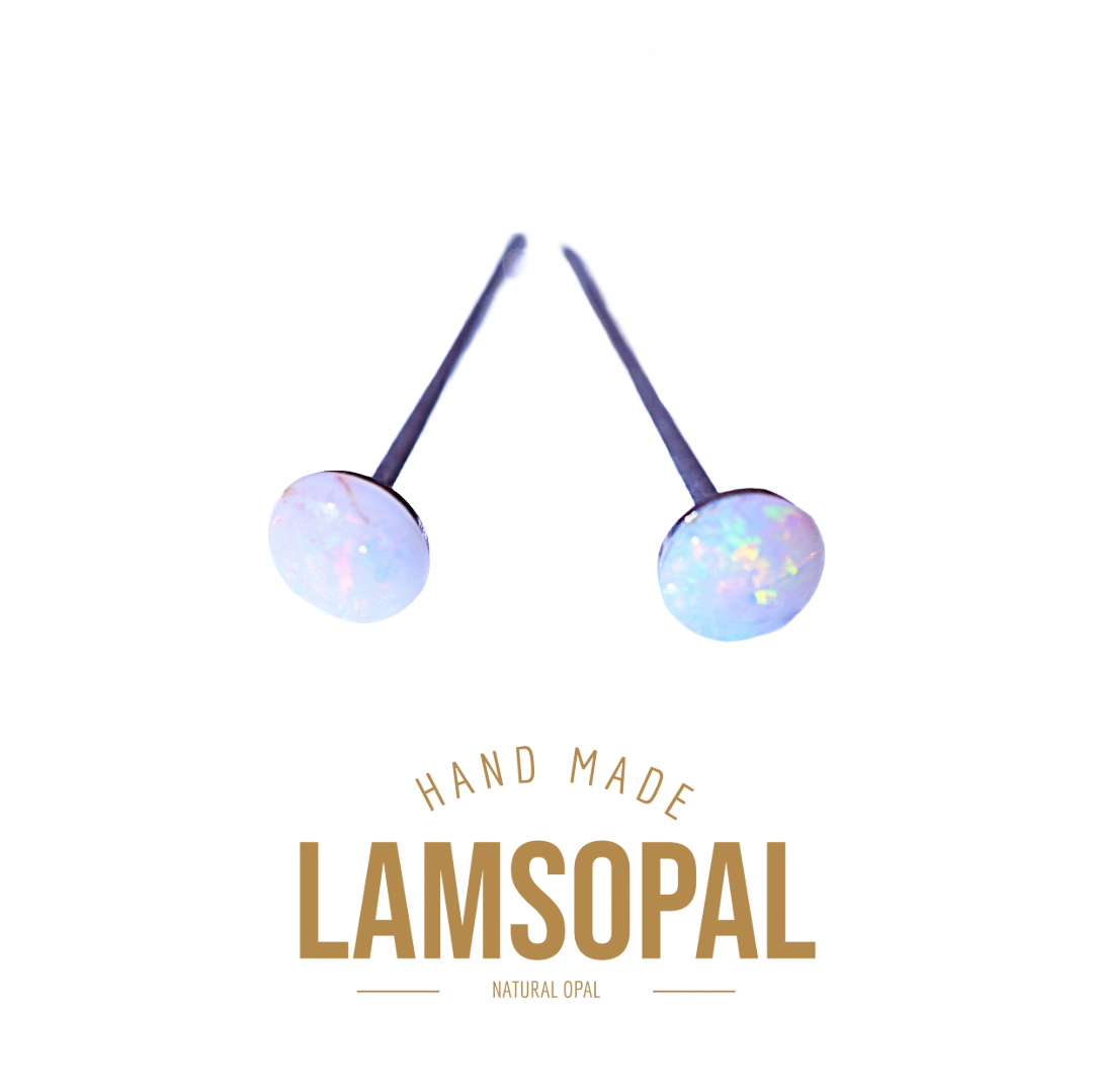 Two Lamsopal natural opal stud earrings with round iridescent opal discs on dark metal posts, displayed above gold-colored text reading 'HAND MADE LAMSOPAL NATURAL OPAL' on a plain white background.