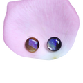 Two round cabochon gemstones, one brown with purple iridescence and one dark blue-black iridescent, displayed on a pink rose petal against a white background.