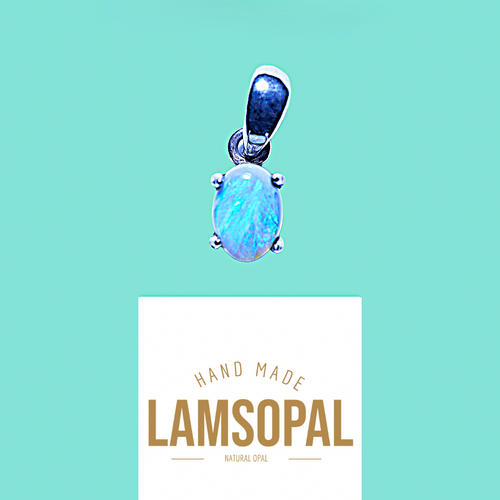A Lamsopal natural opal pendant with a silver bail, shown floating above a white card that reads 'HAND MADE LAMSOPAL NATURAL OPAL' on a solid turquoise background.