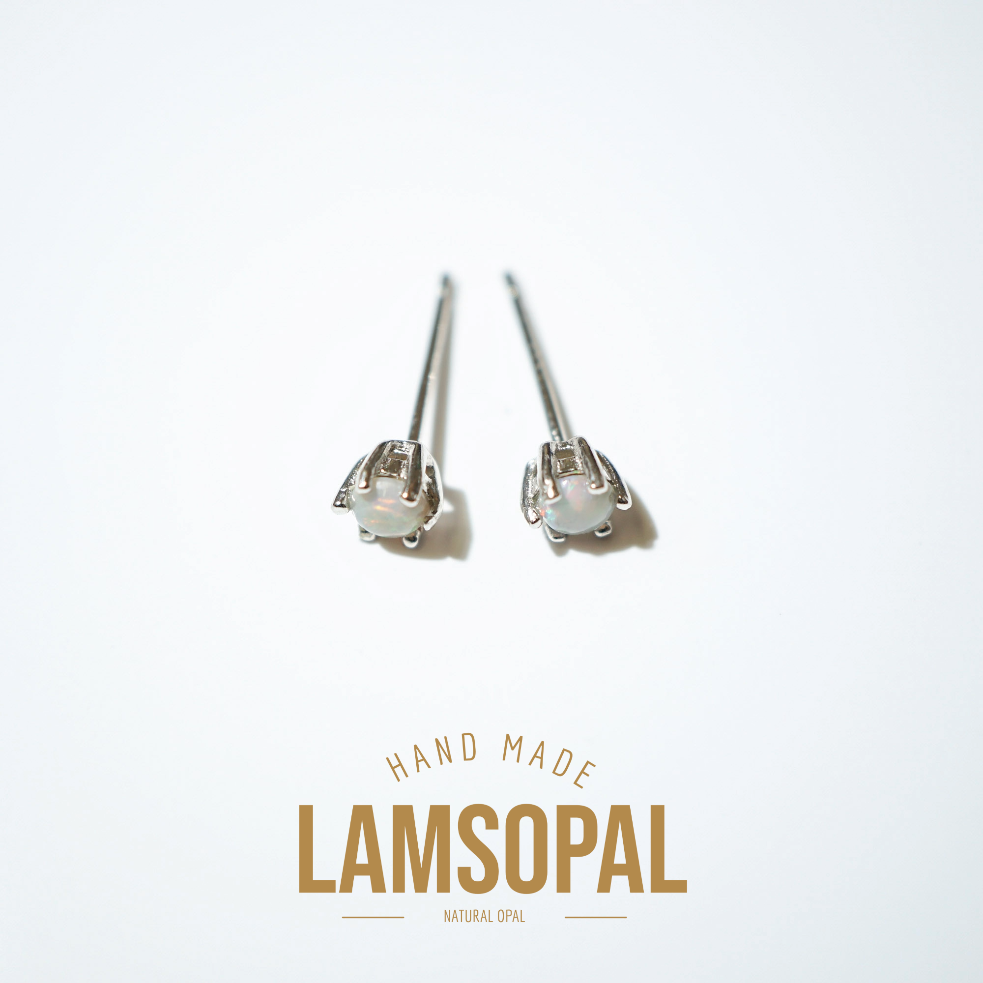 A pair of handmade sterling silver stud earrings with natural opal gemstones, displayed on a clean white background with a gold-colored 'LAMSOPAL' brand logo at the bottom.