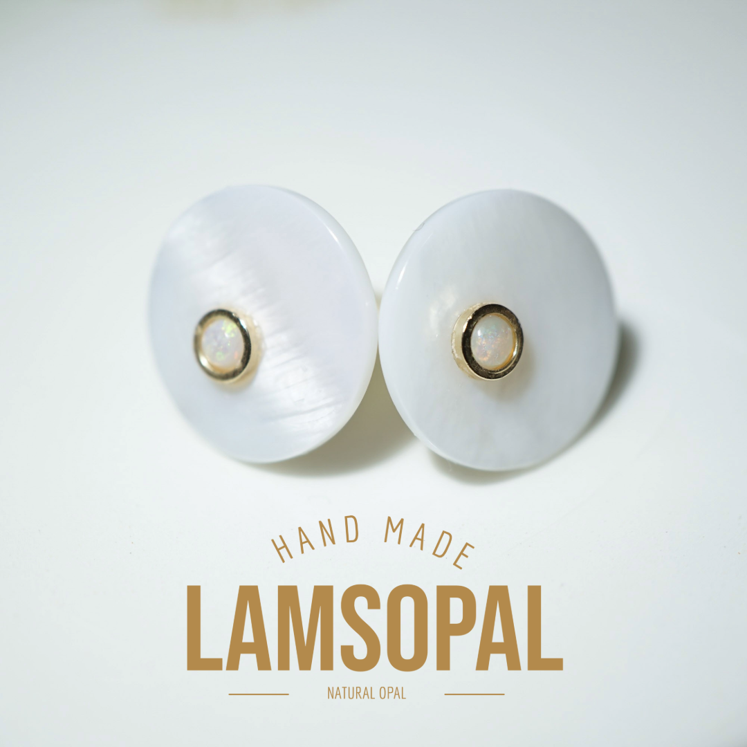 A pair of handmade Lamsopal natural opal stud earrings with round white mother-of-pearl discs and gold bezel-set opal centers, displayed on a clean white background with 'HAND MADE LAMSOPAL' text below.