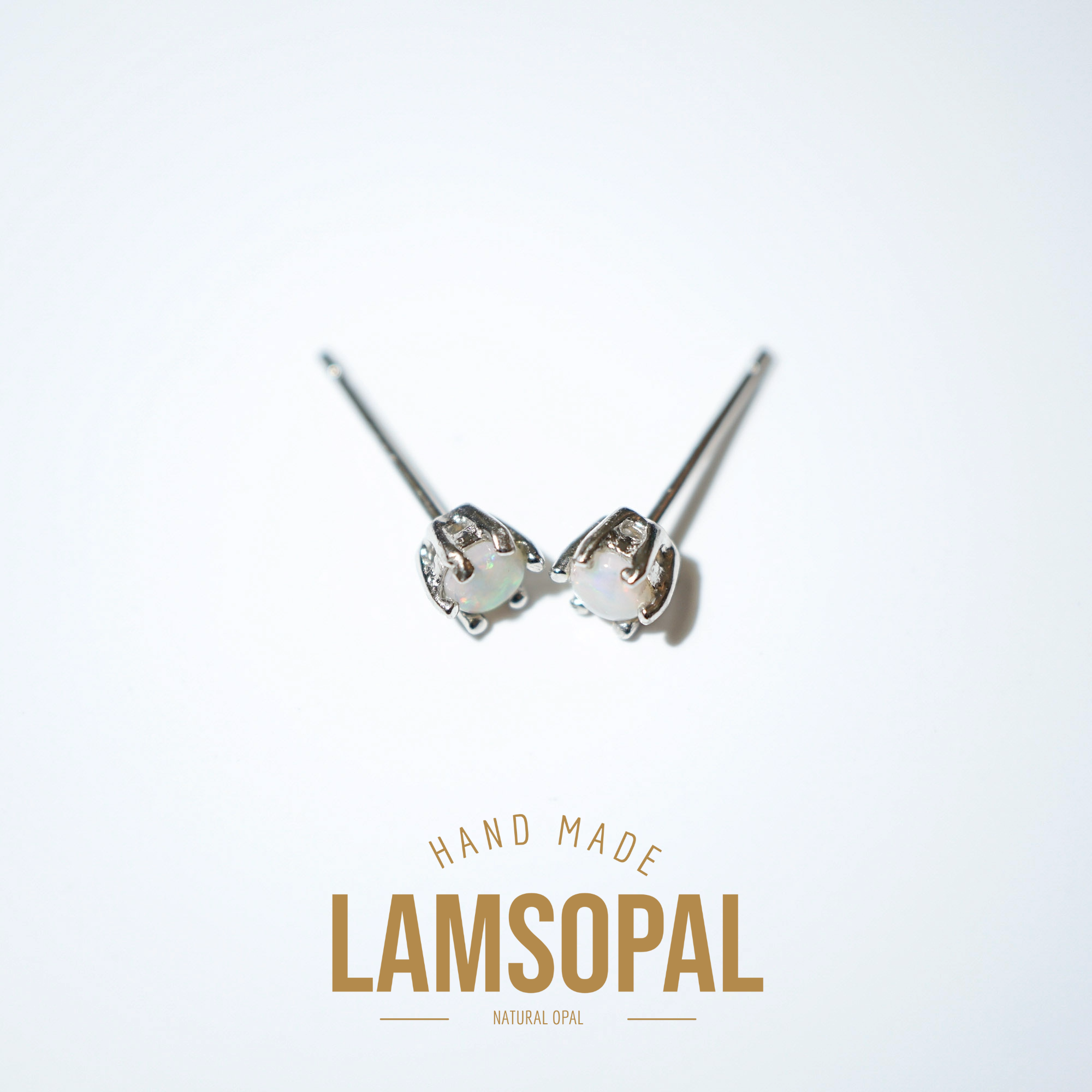 A pair of handmade Lamsopal stud earrings featuring natural opal gemstones in a silver setting, displayed on a clean white background with 'HAND MADE LAMSOPAL NATURAL OPAL' text below.