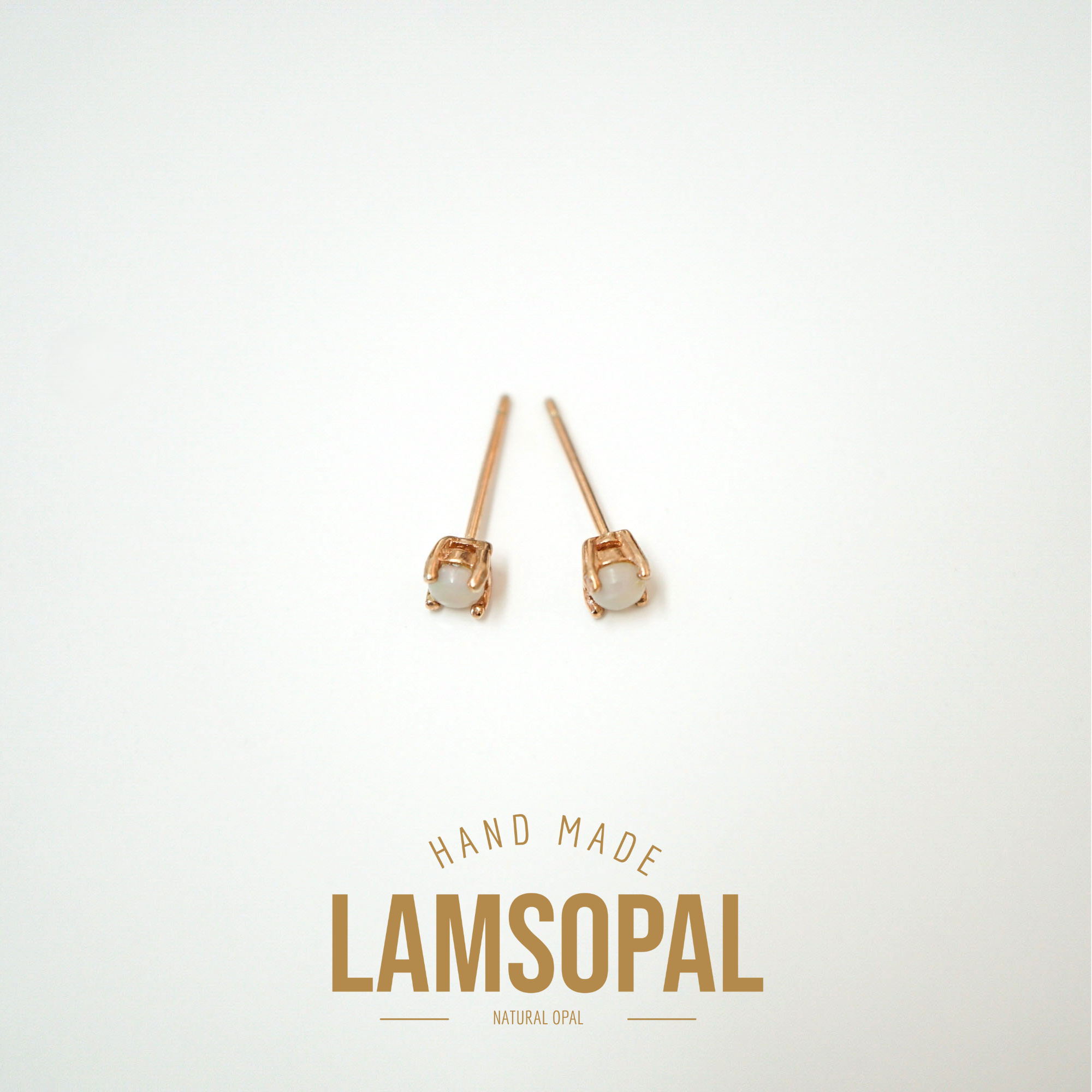 A pair of rose gold stud earrings with natural opal centers, displayed on a clean white background with 'HAND MADE LAMSOPAL NATURAL OPAL' text below.