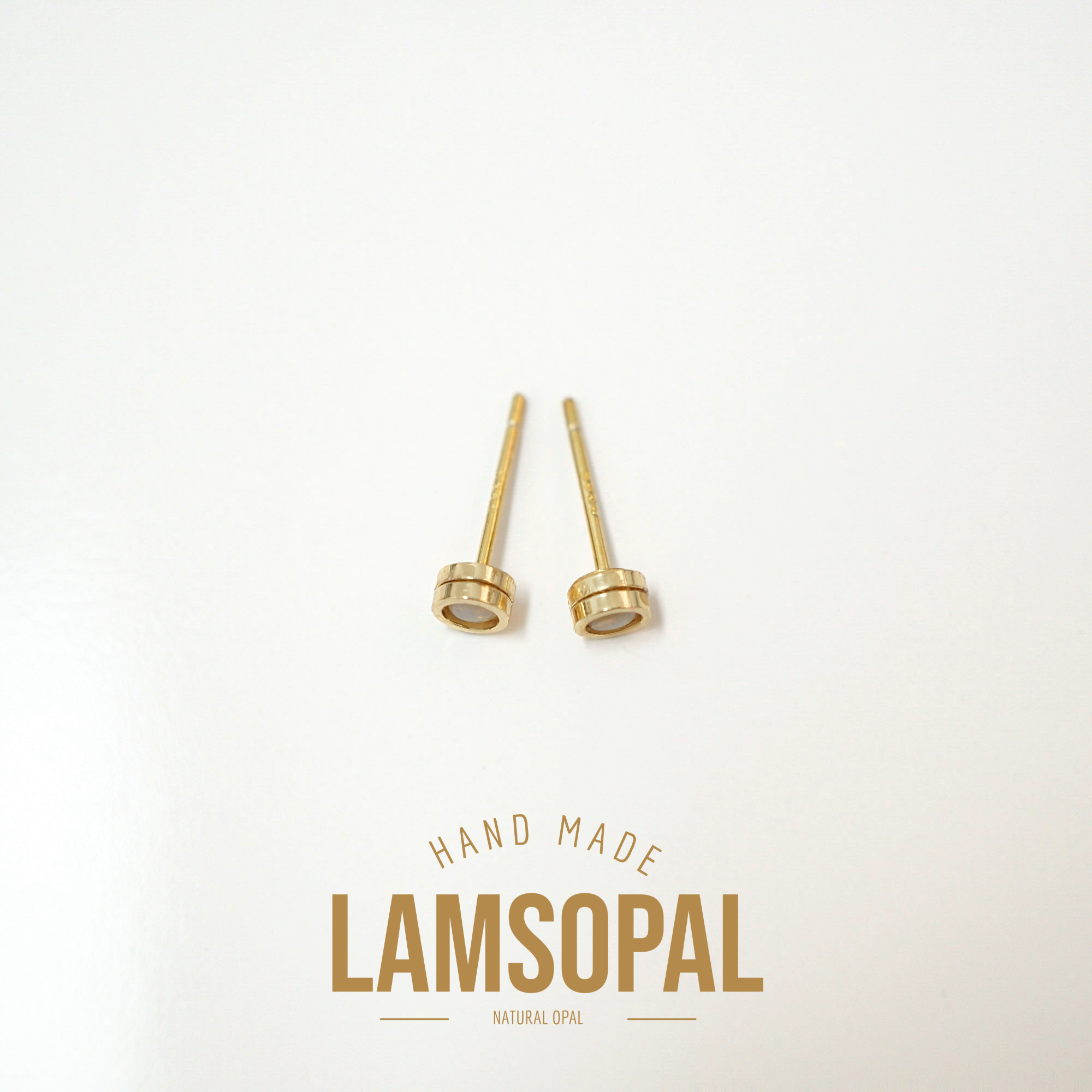 Two gold-toned natural opal lamsonpal beads on a clean white background, with 'HAND MADE LAMSOPAL NATURAL OPAL' text printed below.