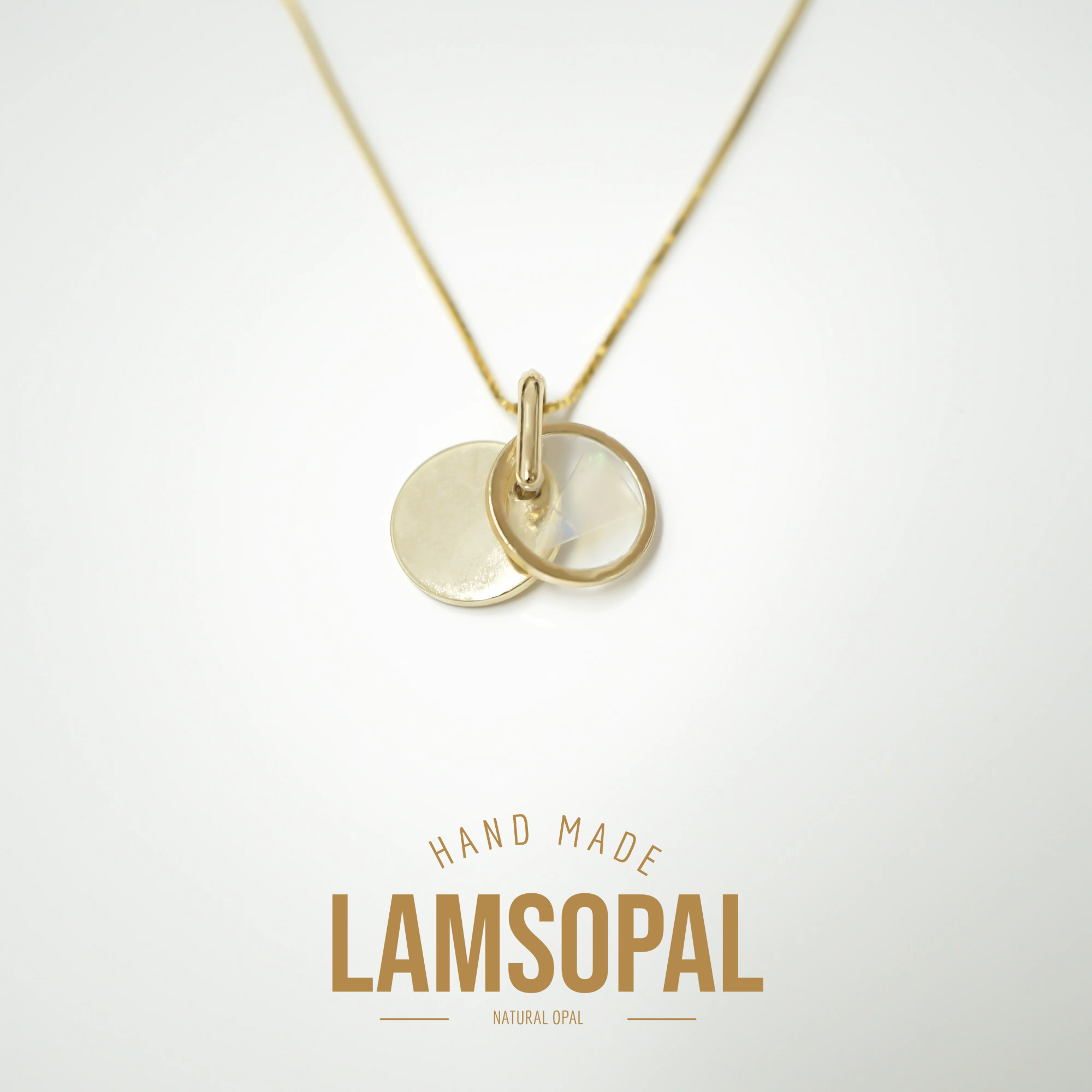 A gold disc pendant necklace with two overlapping circular pendants on a thin chain, shown against a light gray background with the text 'HAND MADE LAMSOPAL NATURAL OPAL' below.