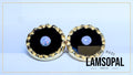 A pair of Lamsopal handmade stud earrings featuring a central natural opal gemstone surrounded by a black inlay and a textured gold-tone scalloped outer rim, set against a light blue background.