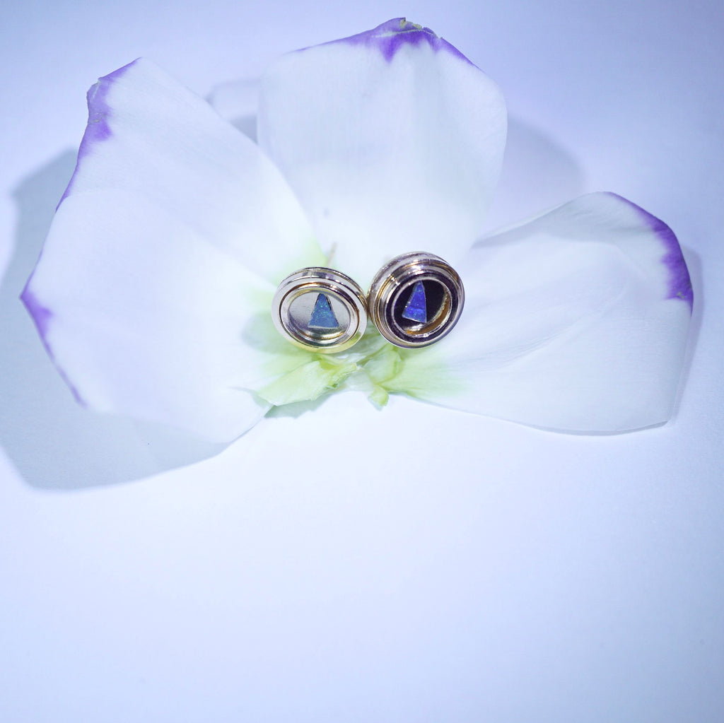Pair of earrings on a white orchid flower