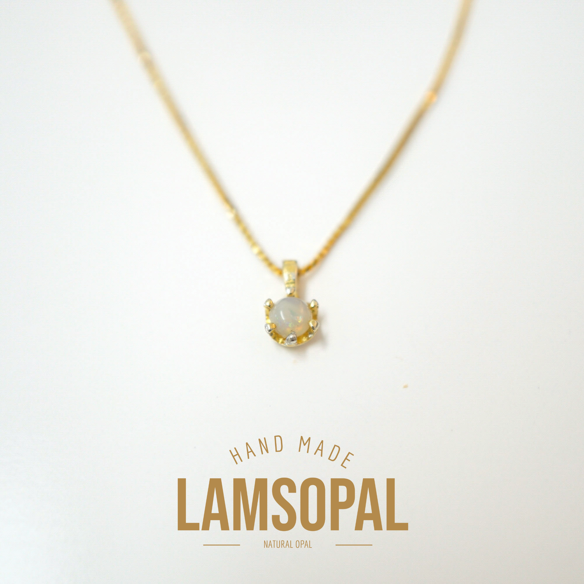 A gold chain necklace with a small pendant featuring a natural opal stone, displayed on a clean white background with a gold 'LAMSOPAL' brand logo at the bottom.