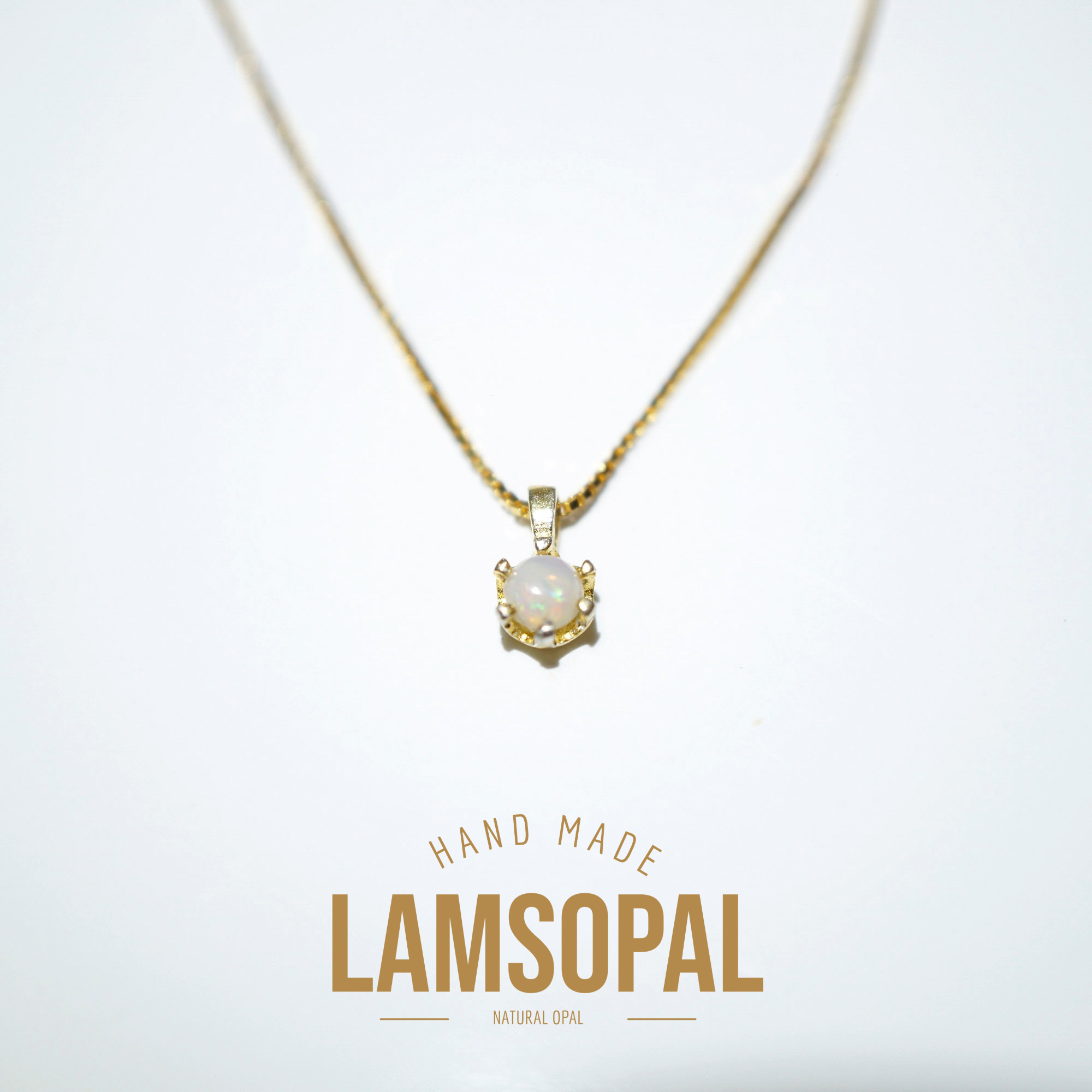 A gold necklace with a pendant featuring a natural opal gemstone, displayed on a clean white background with 'HAND MADE LAMSOPAL NATURAL OPAL' text below.