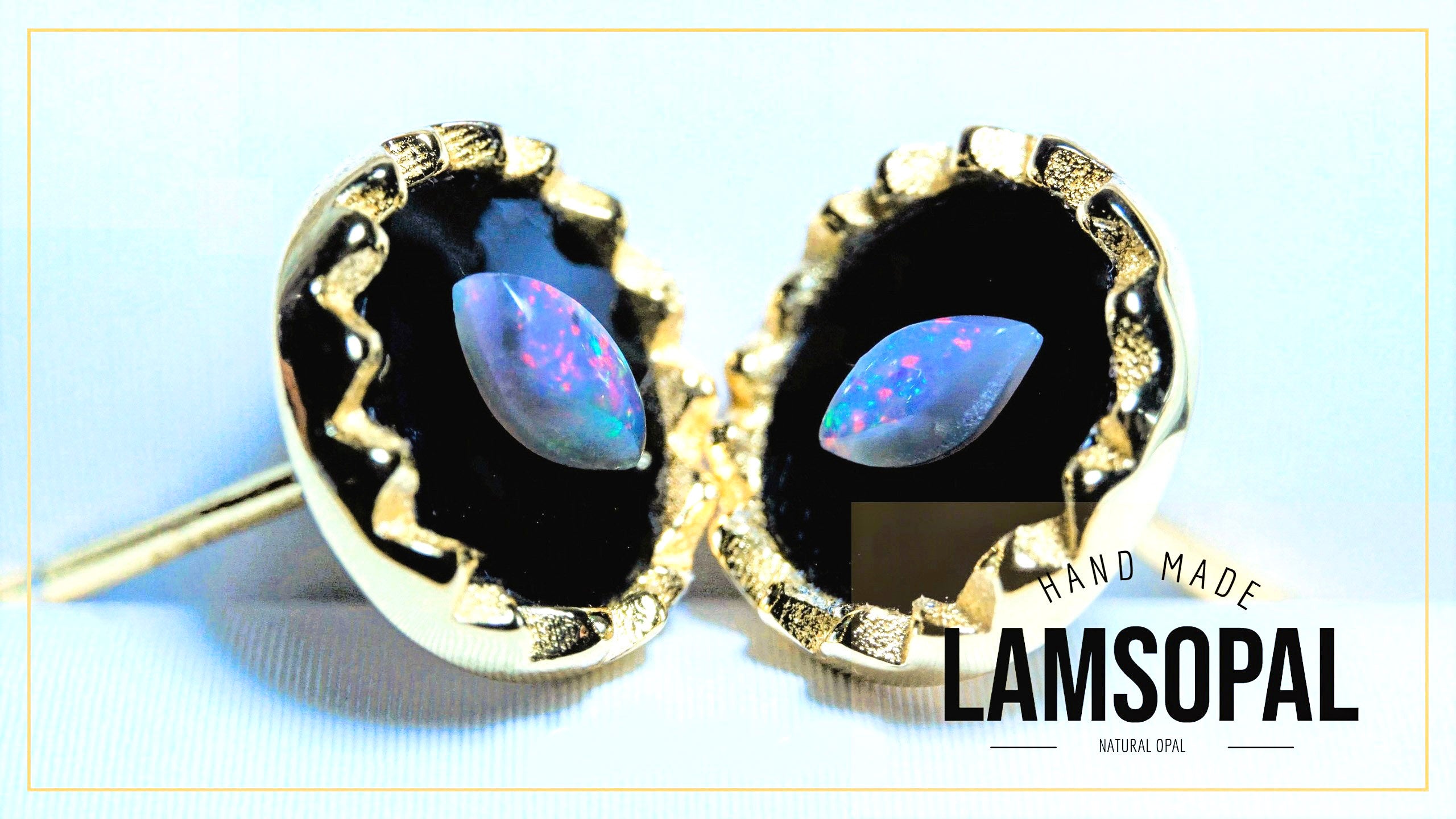 Gold-framed earrings with opal stones on a light blue background, featuring 'LAMSOPAL' branding.