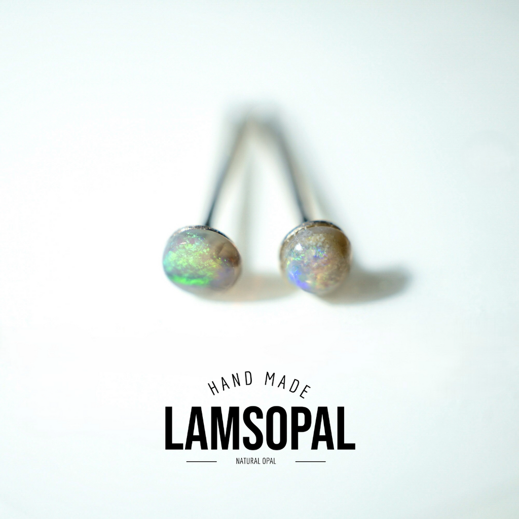 A pair of natural opal stud earrings with dark metal posts, displayed on a clean white background with a 'HAND MADE LAMSOPAL NATURAL OPAL' text overlay at the bottom.