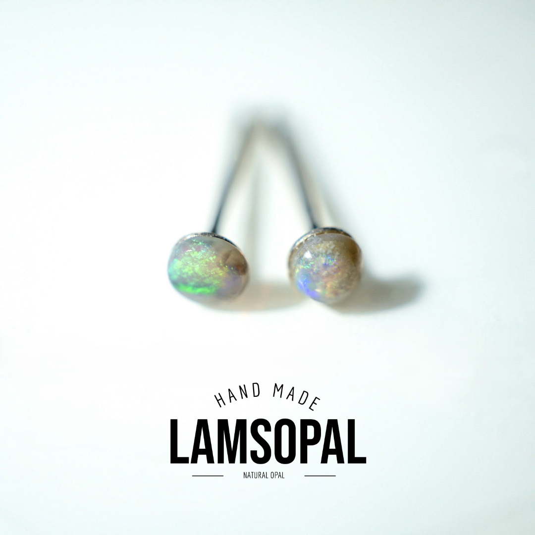 A pair of natural opal stud earrings with dark metal posts, displayed on a clean white background with a 'HAND MADE LAMSOPAL NATURAL OPAL' text overlay at the bottom.