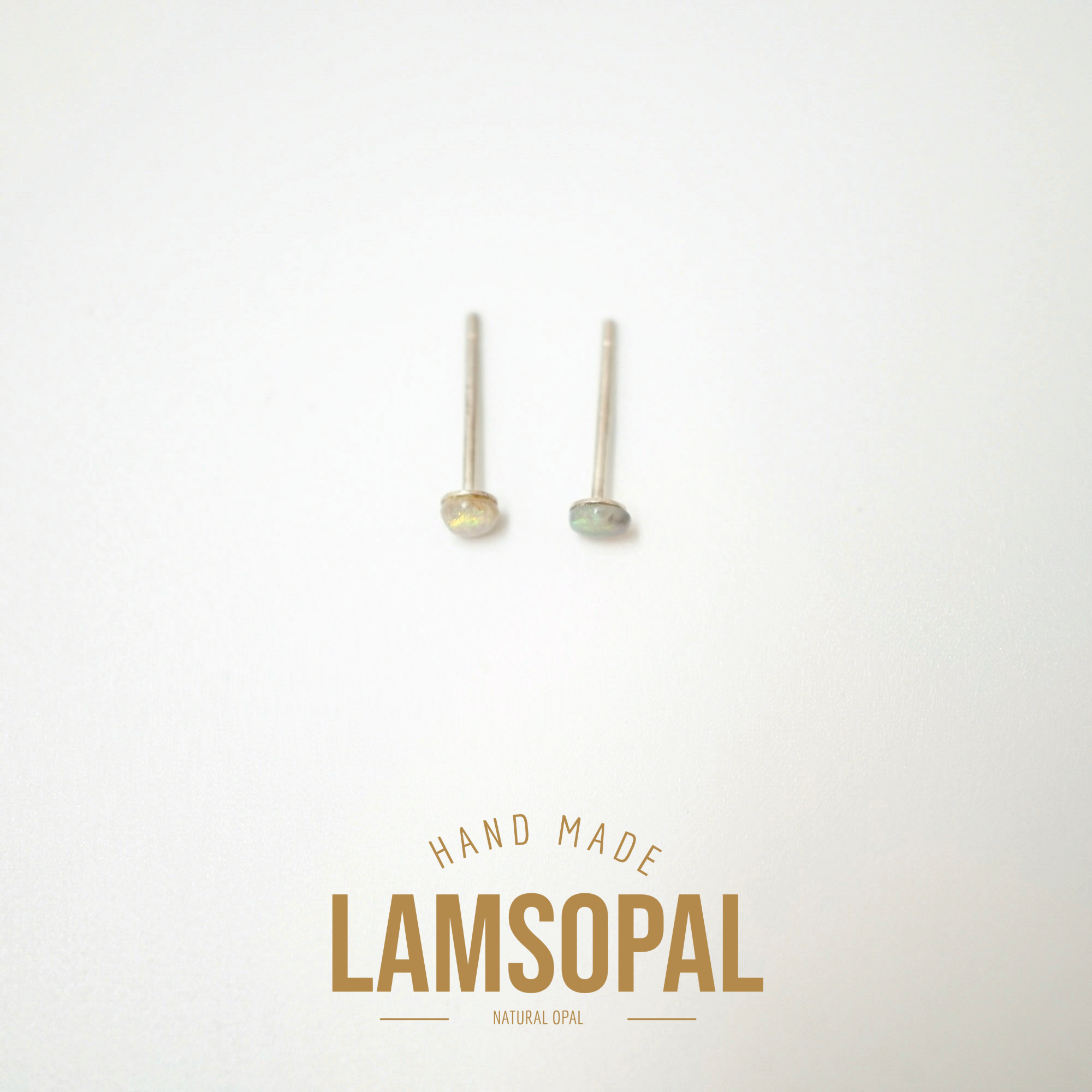 A pair of natural opal stud earrings with gold-toned posts, displayed on a clean white background with a gold 'LAMSOPAL HAND MADE' logo at the bottom.