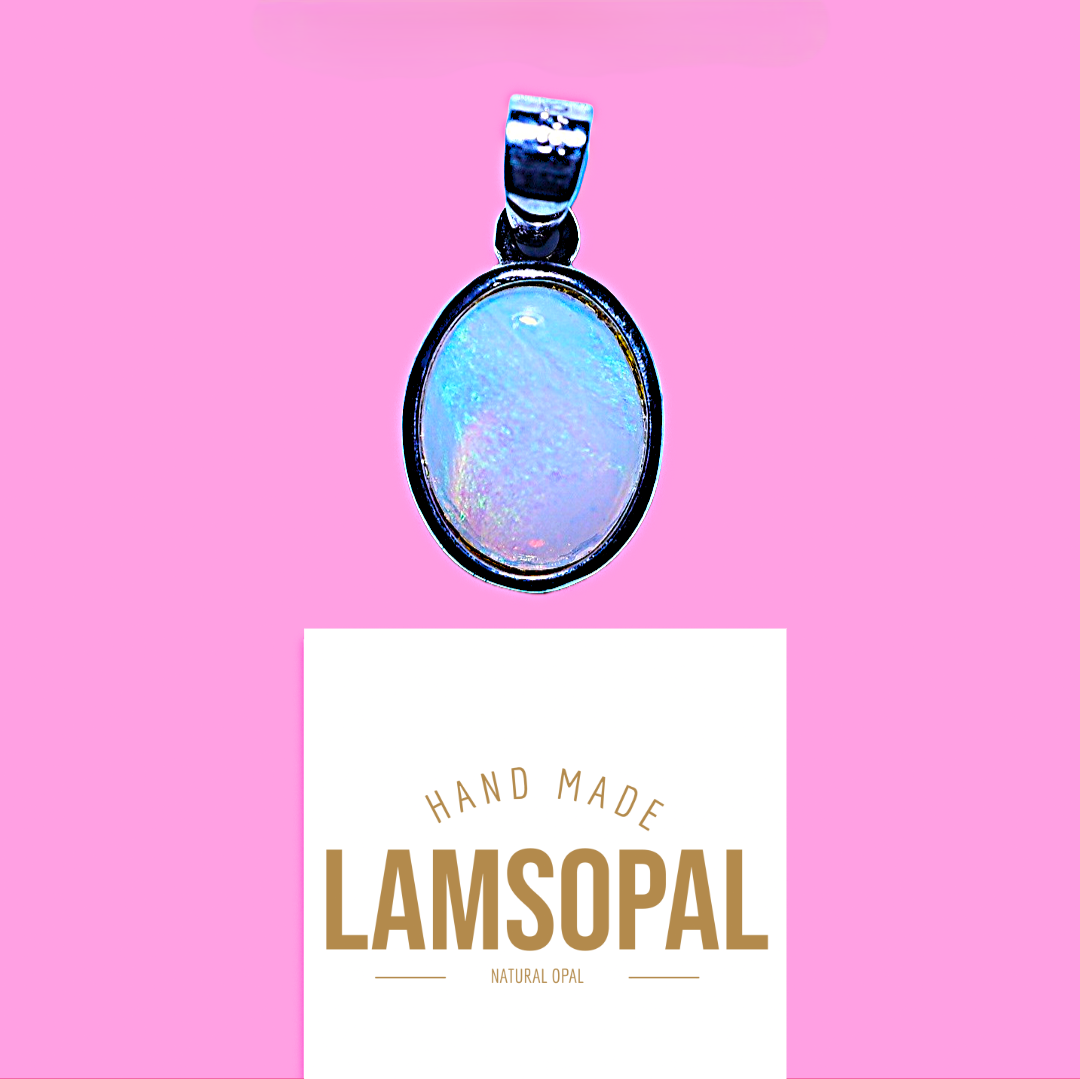 An oval pendant with a black bezel and a light blue iridescent opal center, shown above a white card that reads 'HAND MADE LAMSOPAL NATURAL OPAL' on a solid pink background.