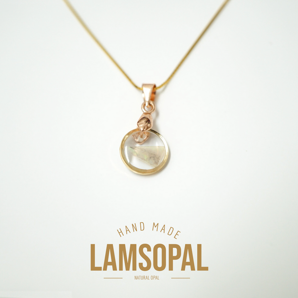 A rose gold necklace with a circular pendant containing a natural opal inlay, displayed on a clean white background with 'HAND MADE LAMSOPAL NATURAL OPAL' text below.
