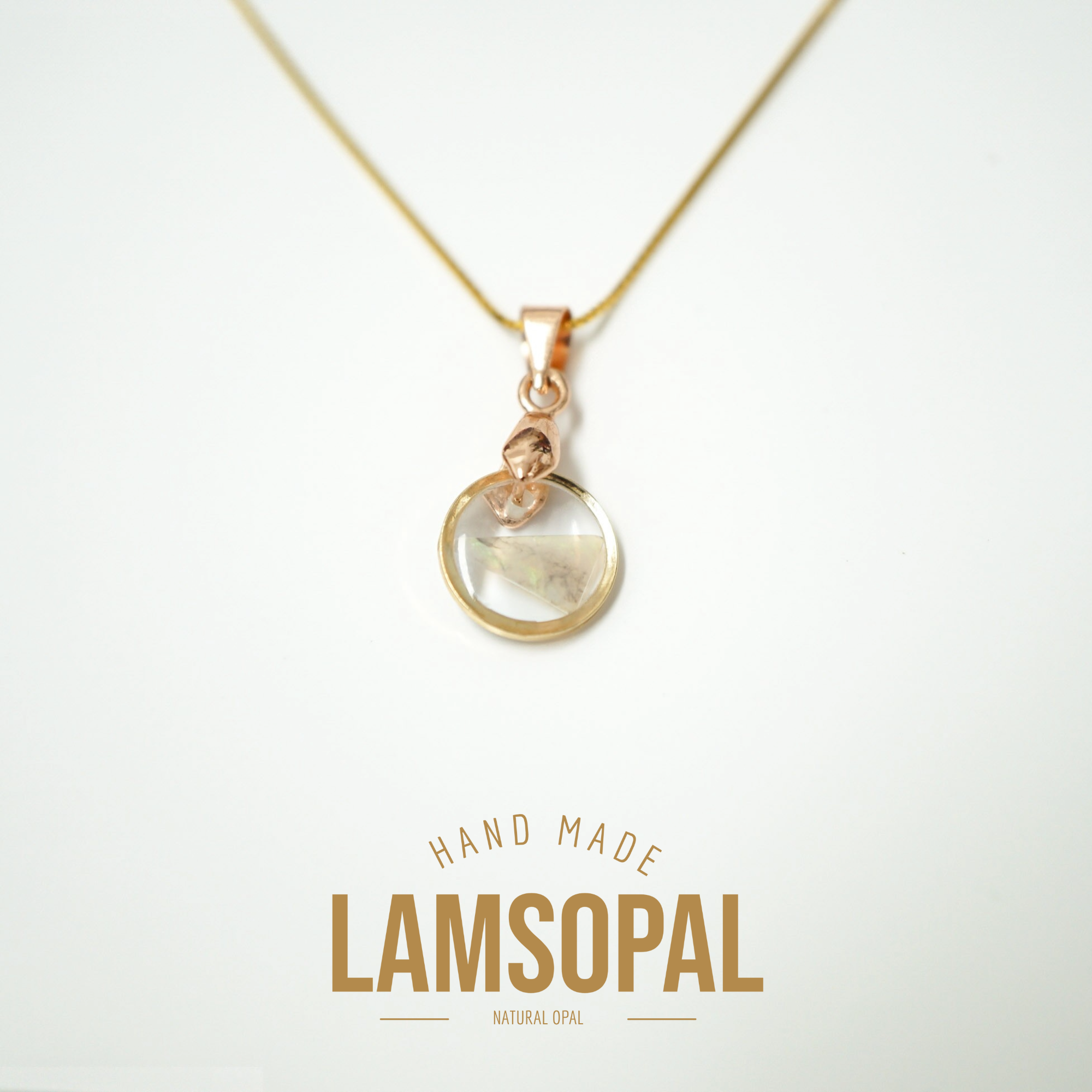 A rose gold necklace with a circular pendant containing a natural opal inlay, displayed on a clean white background with 'HAND MADE LAMSOPAL NATURAL OPAL' text below.