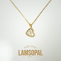 A gold heart-shaped pendant necklace with a clear, polished inlay, displayed on a white background with a gold 'LAMSOPAL HAND MADE' logo overlay at the bottom.