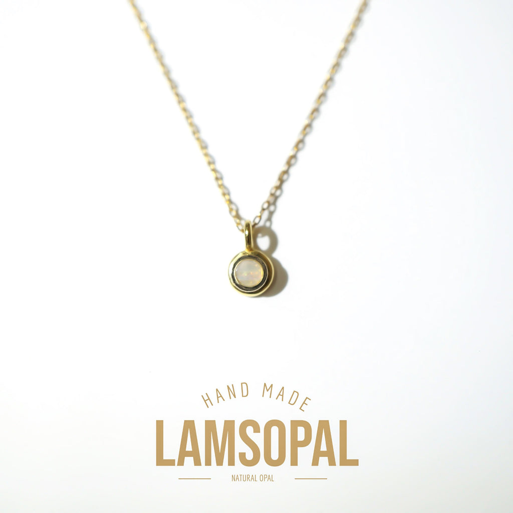 A gold chain necklace with a small oval pendant featuring a natural opal in a bezel setting, displayed on a clean white background with 'HAND MADE LAMSOPAL NATURAL OPAL' text below.