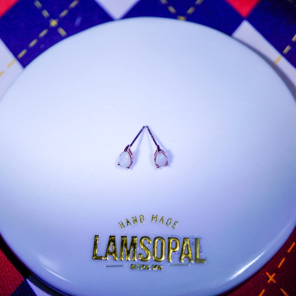 Rose gold plated teardrop Opal Earrings with 'LAMSOPAL Jewellery' branding white ceramic plate