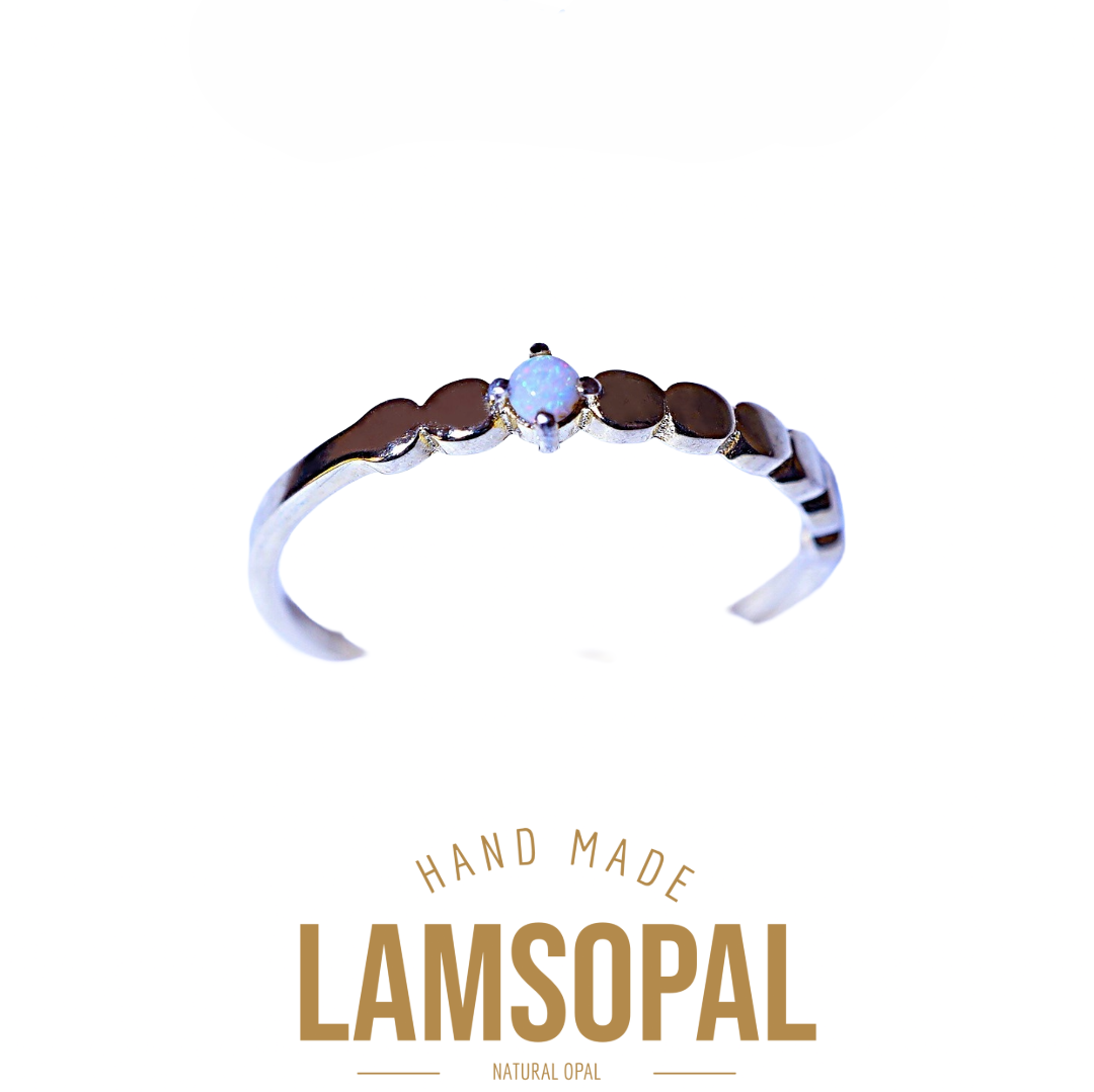 A silver-toned open ring band featuring a central natural opal gemstone and a row of dark brown inlay stones, shown on a white background with 'LAMSOPAL' branding and 'HAND MADE' text below.