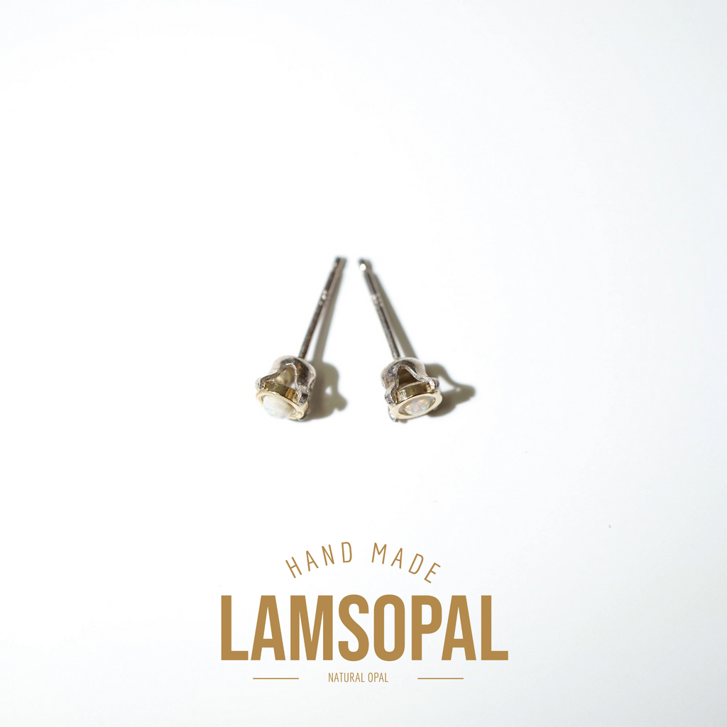 A pair of handmade Lamsopal natural opal stud earrings with silver posts, displayed on a clean white background with a gold-colored brand logo overlay at the bottom.