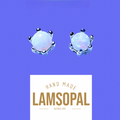 A pair of handmade crown-shaped opal stud earrings with silver settings and white iridescent opal centers, shown above a white label that reads 'HAND MADE LAMSOPAL NATURAL OPAL' on a solid purple background.