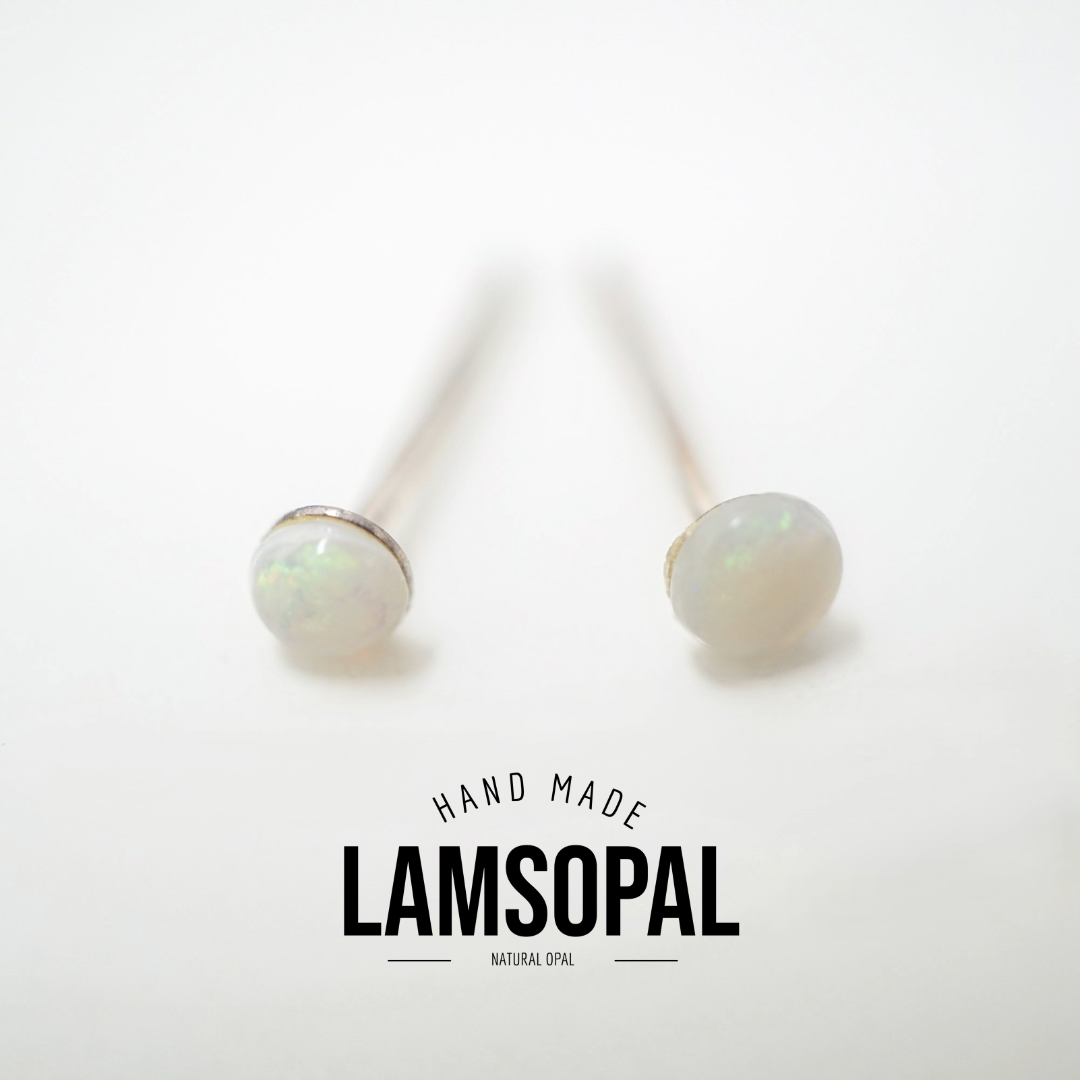 A pair of handmade stud earrings with round white natural opal cabochons on silver-toned posts, displayed on a clean white background with a 'LAMSOPAL' brand logo overlay.