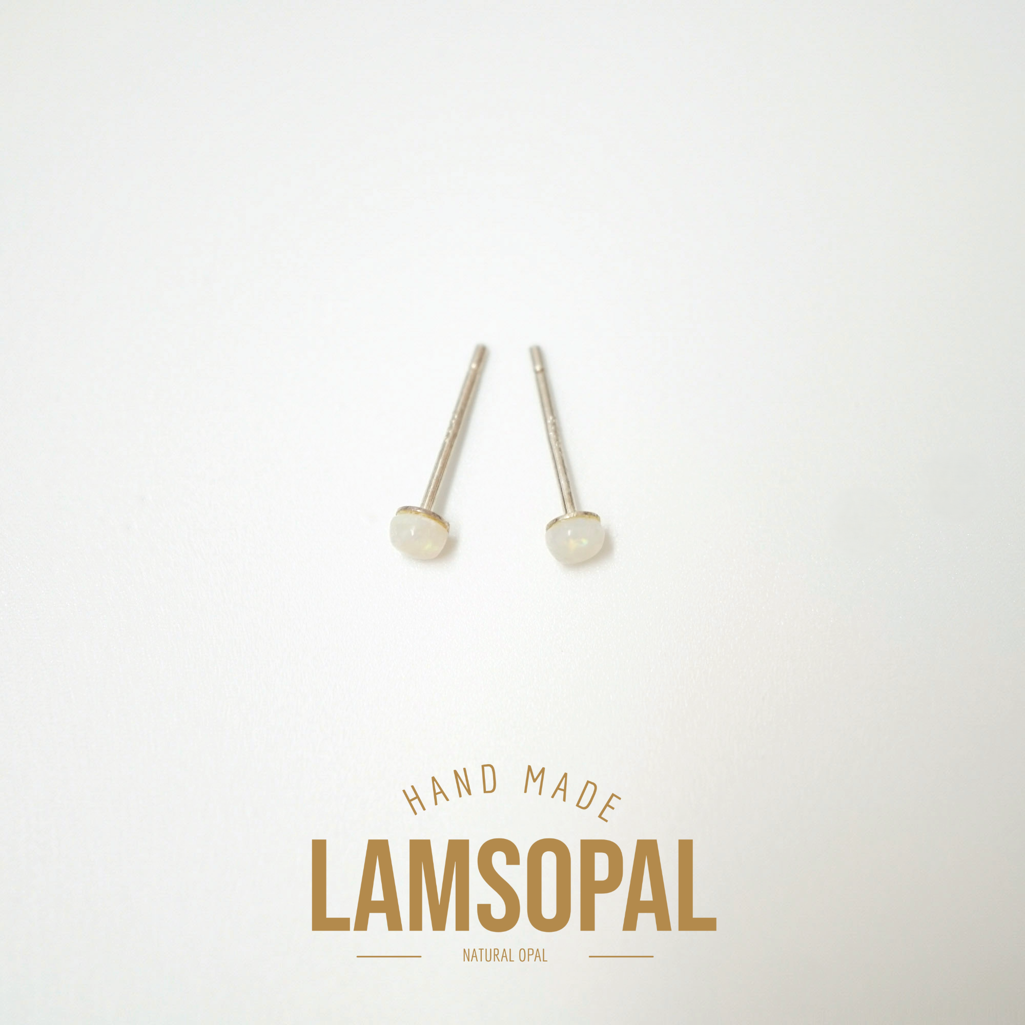 A pair of natural opal stud earrings with silver posts, displayed on a clean white background with a gold 'LAMSOPAL HAND MADE' logo overlay at the bottom.