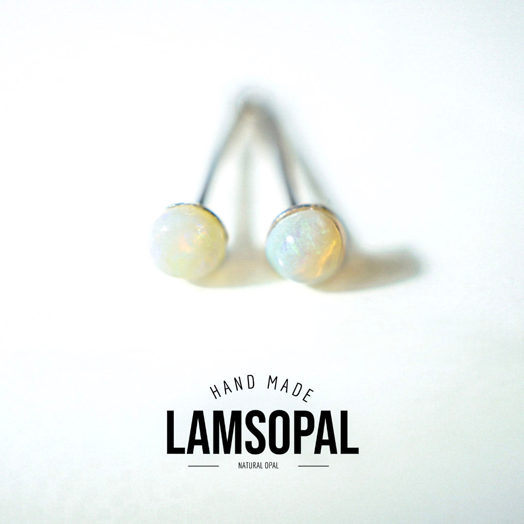 A pair of natural opal stud earrings with silver posts, shown on a white background with a 'LAMSOPAL' brand logo overlay at the bottom.