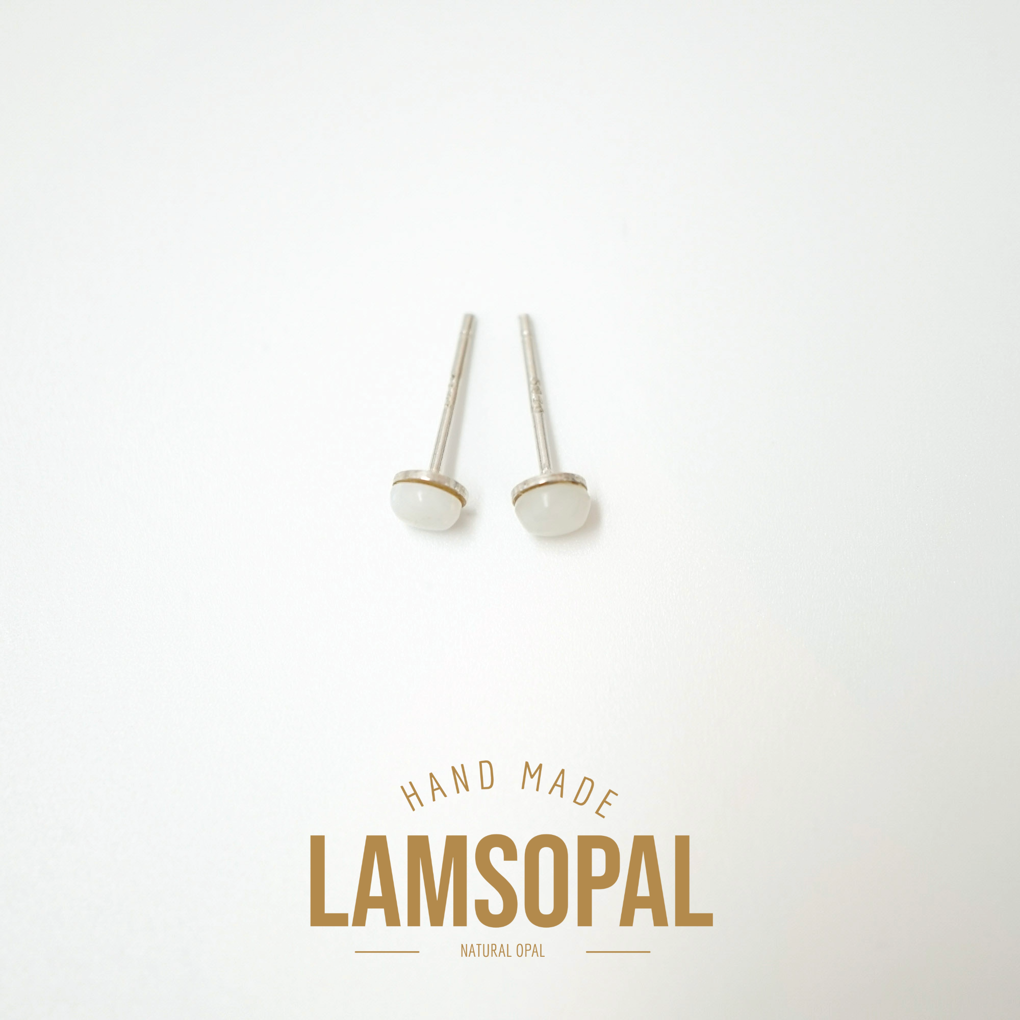 A pair of handmade Lamsopal natural opal stud earrings with silver posts, displayed on a clean white background with a gold 'HAND MADE LAMSOPAL' logo at the bottom.