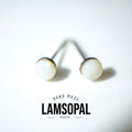 A pair of Lamsopal natural opal stud earrings with white iridescent cabochons and silver posts, displayed on a clean white background with a brand logo overlay.