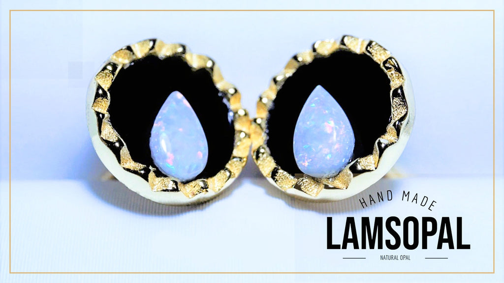 A pair of Lamsopal hand-made natural opal stud earrings with gold bezel settings and a black inlay, displayed on a light blue background with a white border and text overlay.